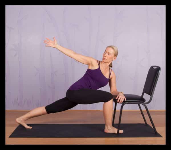 A modified version of the Revolved Side Angle yoga pose using a chair ...
